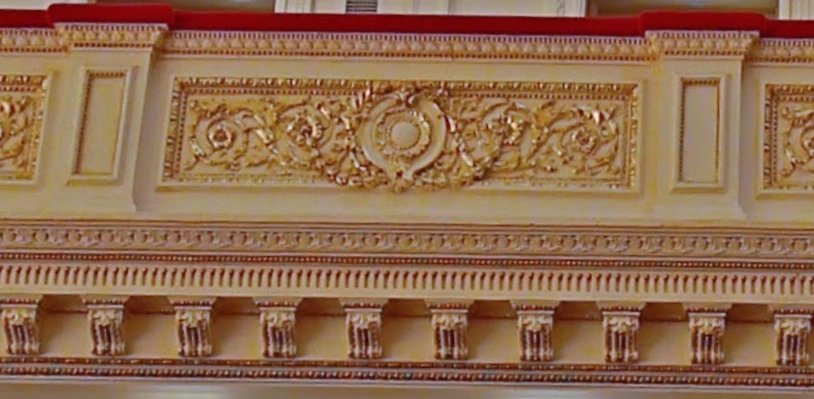 Reference photo of the first tier parapet with gilded panels and brackets